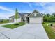 Wide view of two homes with green siding, attached garages, and a concrete driveway at 9711 Palermo Ave, Indianapolis, IN 46239