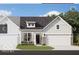 Two-story craftsman style home with white siding, brick accents, and a two-car garage at 9711 Palermo Ave, Indianapolis, IN 46239