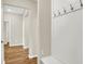 Inviting hallway featuring hardwood flooring, a built-in coat rack, and a clear view to the other rooms at 9711 Palermo Ave, Indianapolis, IN 46239