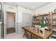 Spacious home office with a desk, built-in shelving, and access to a hallway at 9711 Palermo Ave, Indianapolis, IN 46239