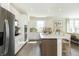 Open concept kitchen with white cabinets, large island, and stainless steel appliances at 9711 Palermo Ave, Indianapolis, IN 46239