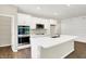 Contemporary kitchen featuring a large island, modern appliances, and ample white cabinetry at 9711 Palermo Ave, Indianapolis, IN 46239