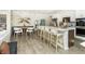 Modern kitchen with white cabinets, breakfast nook, and an island with seating at 9711 Palermo Ave, Indianapolis, IN 46239
