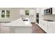 Modern kitchen with white cabinetry, stainless steel appliances, and a large island with a sink at 9711 Palermo Ave, Indianapolis, IN 46239