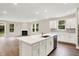 Spacious open-concept kitchen featuring a large island and seamless flow to a bright living room with a fireplace at 9711 Palermo Ave, Indianapolis, IN 46239