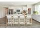 Spacious kitchen with white cabinets, island, stainless steel appliances, and hardwood floors at 9711 Palermo Ave, Indianapolis, IN 46239