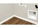 Corner of a laundry area with hookups and wood-look flooring at 9711 Palermo Ave, Indianapolis, IN 46239