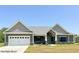 Craftsman style home with gray siding, white garage door, and covered porch at Lot 34 Doe Meadow Dr, Anderson, IN 46011
