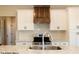 Modern kitchen with white cabinets, stainless steel appliances, and a wooden vent hood at Lot 34 Doe Meadow Dr, Anderson, IN 46011