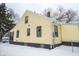 Rear view of charming yellow house with dark grey accents at 1302 Ingomar St, Indianapolis, IN 46241