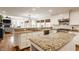 Open concept kitchen with granite island and stainless steel appliances at 1303 Meadowbrook Dr, Indianapolis, IN 46240