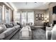 Living room with sectional sofa, ottoman, and fireplace at 13232 Broad St, Carmel, IN 46032