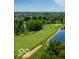 Golf course community with pond and lush green landscape at 15365 Mystic Rock Dr, Carmel, IN 46033