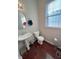 Small bathroom with pedestal sink and hardwood floor at 15365 Mystic Rock Dr, Carmel, IN 46033