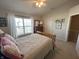 Bright bedroom with wooden furniture, large window, and ceiling fan at 15365 Mystic Rock Dr, Carmel, IN 46033