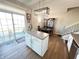 Modern kitchen with white cabinets, island, and dining area with access to balcony at 15365 Mystic Rock Dr, Carmel, IN 46033