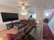 Open living area with sectional sofa, large TV, and view into kitchen at 15365 Mystic Rock Dr, Carmel, IN 46033