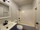 Updated bathroom with a tub, vanity, and dark fixtures at 1608 Edgecombe Ave, Indianapolis, IN 46227