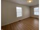 Bright bedroom with wood-look floors and neutral walls at 1608 Edgecombe Ave, Indianapolis, IN 46227