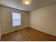 Bright bedroom with light wood floors and a window at 1608 Edgecombe Ave, Indianapolis, IN 46227