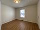 Spacious bedroom featuring light wood floors and a window with blinds at 1608 Edgecombe Ave, Indianapolis, IN 46227