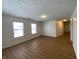 Spacious living room with wood-look floors and neutral walls at 1608 Edgecombe Ave, Indianapolis, IN 46227