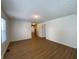 Spacious living room with wood-look floors and neutral walls at 1608 Edgecombe Ave, Indianapolis, IN 46227