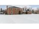 Brick home's backyard view, covered in snow at 1716 Westwood Dr, Anderson, IN 46011