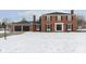 Brick house with 2-car garage and snow-covered lawn at 1716 Westwood Dr, Anderson, IN 46011