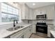 Modern kitchen with stainless steel appliances and granite countertops at 1716 Westwood Dr, Anderson, IN 46011