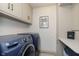 Laundry room with washer, dryer, and cabinets at 1716 Westwood Dr, Anderson, IN 46011