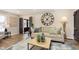 Bright living room features hardwood floors, comfy sofa, and large clock at 1716 Westwood Dr, Anderson, IN 46011