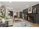 Living room boasts a fireplace, hardwood floors and a large clock at 1716 Westwood Dr, Anderson, IN 46011