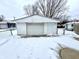 Detached garage with single car door in snowy backyard at 176 Monroe St, Indianapolis, IN 46229