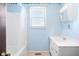 Light blue bathroom with white tub and shower, and a vanity at 2227 Chestnut St, Columbus, IN 47201