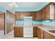 Kitchen features white stove and wood cabinets at 2227 Chestnut St, Columbus, IN 47201