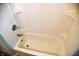 White bathtub with shower surround and built-in shelves at 2606 13Th St, Columbus, IN 47201