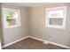 Bright bedroom featuring two windows and wood-look floors at 2606 13Th St, Columbus, IN 47201