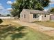 Tan house with a white door, small yard, and driveway at 2606 13Th St, Columbus, IN 47201