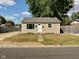 Tan house with a white door, small yard, and driveway at 2606 13Th St, Columbus, IN 47201