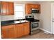 Kitchen with wood cabinets, stainless steel appliances, and vinyl flooring at 2606 13Th St, Columbus, IN 47201