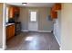 Galley kitchen with wood cabinets, stainless steel appliances, and vinyl flooring at 2606 13Th St, Columbus, IN 47201