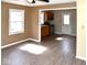 Living room with hardwood floors, neutral walls, and kitchen access at 2606 13Th St, Columbus, IN 47201