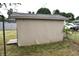 Tan shed in backyard with damaged siding at 2606 13Th St, Columbus, IN 47201