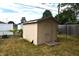 Tan shed in backyard with damaged siding at 2606 13Th St, Columbus, IN 47201