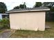 Tan shed in backyard with damaged siding at 2606 13Th St, Columbus, IN 47201