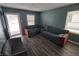 Cozy living room featuring hardwood floors and teal walls at 3016 N Temple Ave, Indianapolis, IN 46218