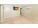 Living room with tan carpet and walls, featuring a large window and door at 3153 Arbutus Dr, Indianapolis, IN 46224