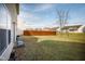 Fenced backyard with grassy area and a tree at 3721 Rinehall Dr, Indianapolis, IN 46235