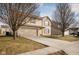 Two-story house with beige siding, attached garage, and driveway at 3721 Rinehall Dr, Indianapolis, IN 46235
